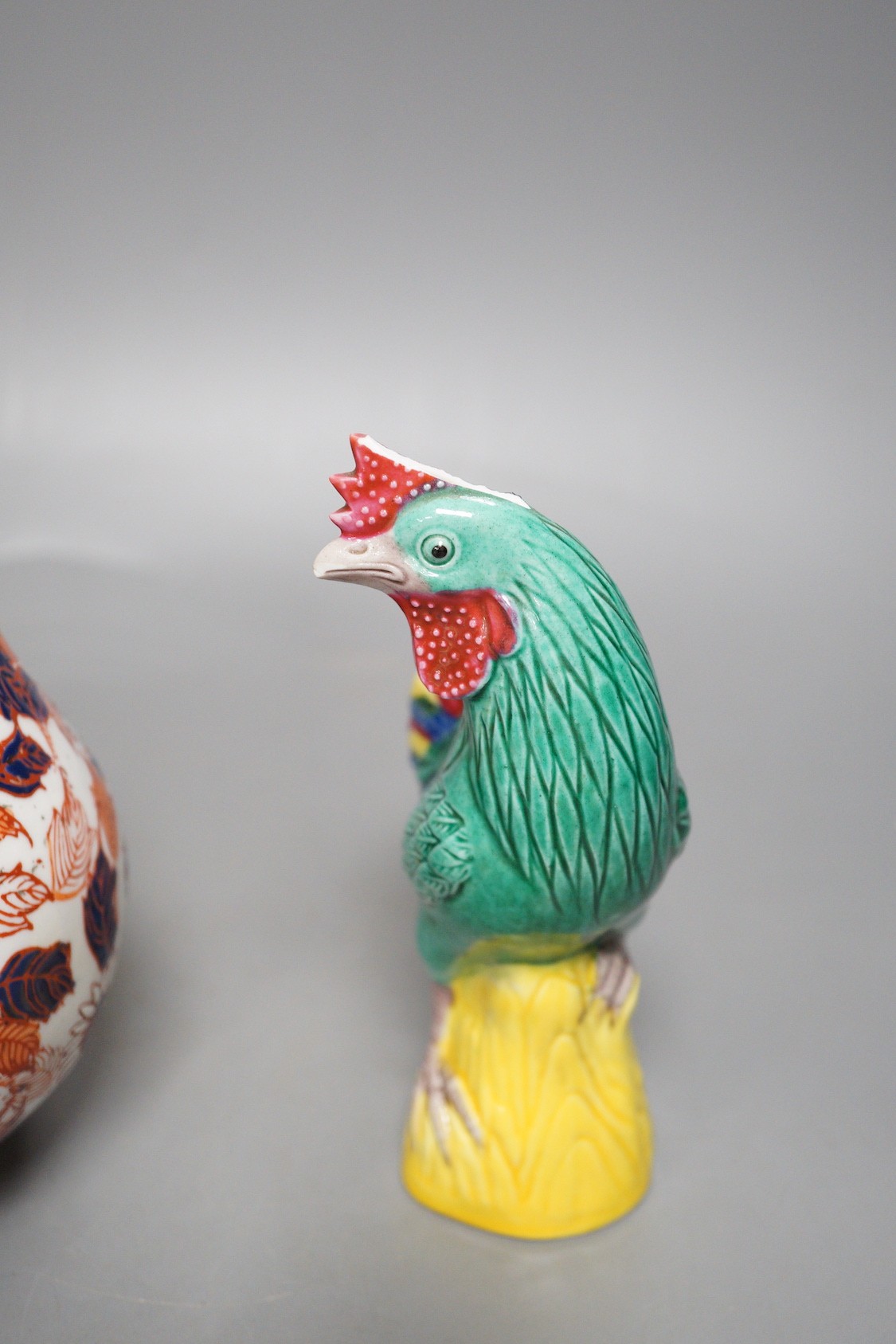 A pair of Chinese pottery roosters and an Imari quail, tallest 15cm